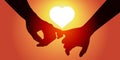 Lovers hold hands in front of a sun forming a heart